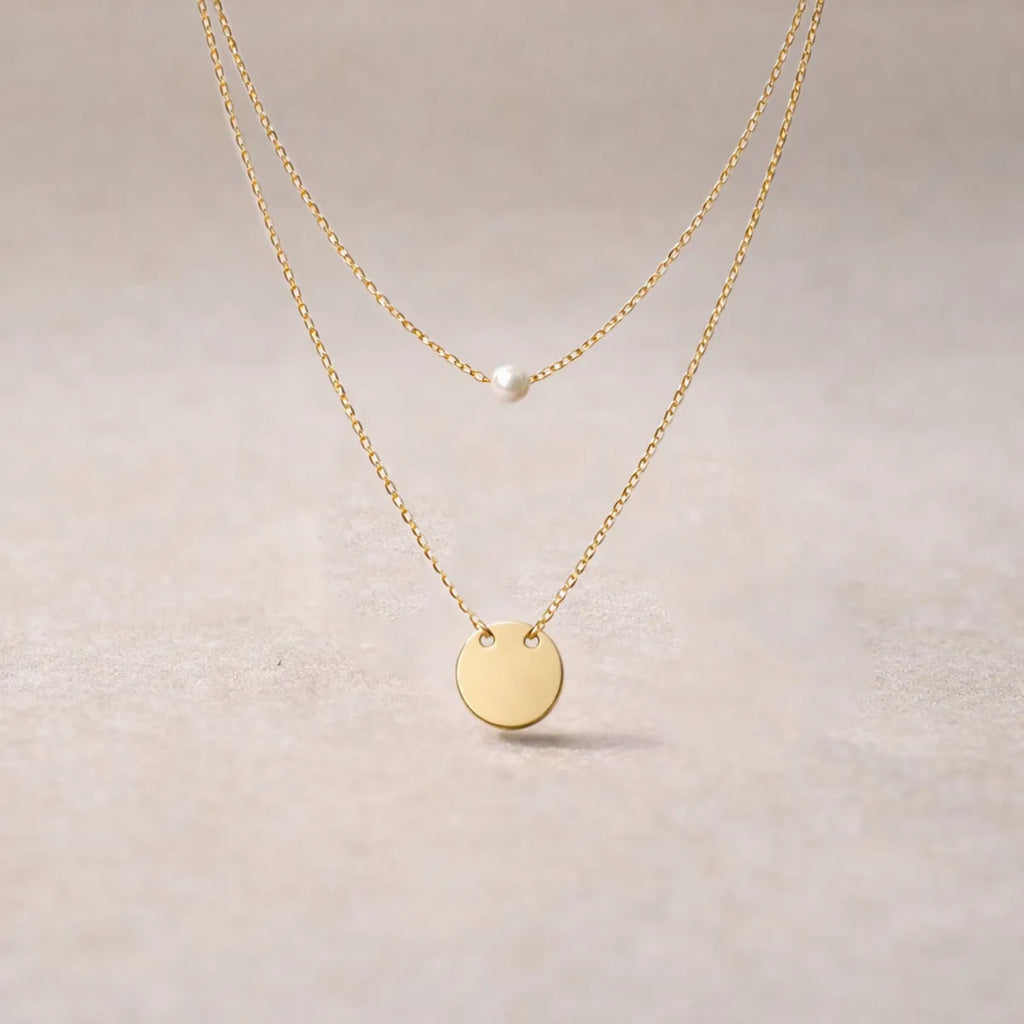 Collier Complice Visée acier inoxydable doré double chaîne perle médaille