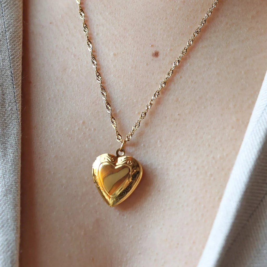 Collier Précieux médaillon cœur en acier doré avec photo souvenir à personnaliser, porté autour du cou.