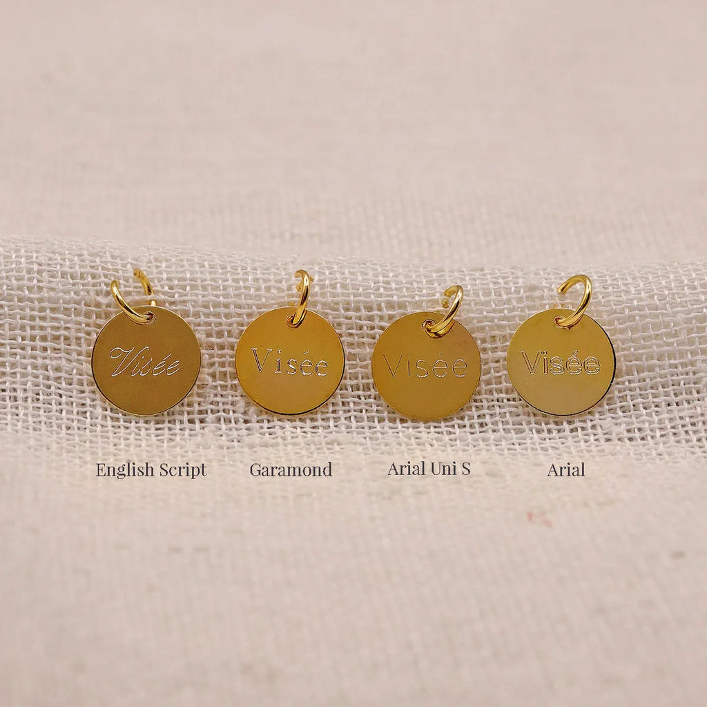 Comparatif des gravures Visée sur médaillons dorés: English Script, Garamond, Arial Uni S et Arial, sur fond tissu écru