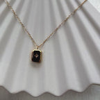 Vidéo du collier "Ma voie" avec pendentif rectangulaire personnalisable en acier doré, sur fond beige texturé.